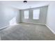 Bright bedroom featuring plush carpeting and natural light from two well placed windows at , Las Vegas, NV 89148