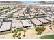 This aerial view showcases a neighborhood with homes that include pools and desert landscaping at 1129 Via Della Curia, Henderson, NV 89011