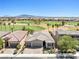 Aerial view of property with pool, landscaped yard, and scenic golf course community at 1129 Via Della Curia, Henderson, NV 89011