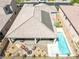 Aerial view of a house showcasing a backyard oasis with a pool, firepit, and covered patio area at 1129 Via Della Curia, Henderson, NV 89011