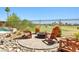 Backyard oasis features seating around a fire pit and view of golf course at 1129 Via Della Curia, Henderson, NV 89011