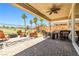 Covered outdoor living space with patio, fire pit, and lush landscaping at 1129 Via Della Curia, Henderson, NV 89011