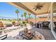 Enjoy the covered patio with outdoor seating, fire pit, and lush landscaping at 1129 Via Della Curia, Henderson, NV 89011