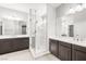 Bright bathroom showcasing double vanities and a modern walk-in shower with glass enclosure at 1129 Via Della Curia, Henderson, NV 89011