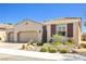 Charming single-story home with a three-car garage and attractive desert landscaping at 1129 Via Della Curia, Henderson, NV 89011
