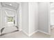 Bright hallway with neutral tones, leading to various rooms and a bathroom at 1129 Via Della Curia, Henderson, NV 89011