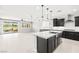 Stylish kitchen boasts dark cabinetry, stainless appliances, and a seamless connection to the outdoor patio at 1129 Via Della Curia, Henderson, NV 89011