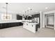 Modern kitchen features dark cabinets, island, and stainless steel appliances at 1129 Via Della Curia, Henderson, NV 89011