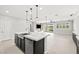 Bright, open kitchen features a large island, stainless steel appliances, and seamless flow to the living area at 1129 Via Della Curia, Henderson, NV 89011