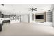 Open-concept living area with a kitchen, a large island and TV entertainment center at 1129 Via Della Curia, Henderson, NV 89011