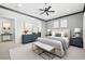 Serene main bedroom featuring a ceiling fan, neutral decor, and a barn door leading to the bathroom at 1129 Via Della Curia, Henderson, NV 89011