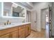 Bright bathroom with a double vanity, modern lighting, and light wood cabinets and floors at 1144 Calico Ridge Dr, Henderson, NV 89011