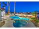 Inviting backyard pool and spa with lush tropical landscaping and outdoor grill area at 1144 Calico Ridge Dr, Henderson, NV 89011
