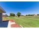 Beautiful backyard with a view of mature trees and neighborhood golf course at 1195 Golf Club Dr, Laughlin, NV 89029