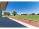 Manicured backyard with views of the community golf course and mature trees at 1195 Golf Club Dr, Laughlin, NV 89029