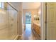Bright bathroom with a glass enclosed shower, double sink vanity, and wood-look flooring at 1195 Golf Club Dr, Laughlin, NV 89029