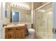 Bathroom featuring a walk-in shower with glass door, wood vanity, and contemporary lighting at 1195 Golf Club Dr, Laughlin, NV 89029