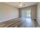 Neutral-toned bedroom with ceiling fan and large sliding glass doors overlooking the backyard at 1195 Golf Club Dr, Laughlin, NV 89029