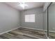 Bedroom featuring neutral walls, wood-look floors, a ceiling fan, and a closet with mirrored sliding doors at 1195 Golf Club Dr, Laughlin, NV 89029