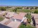 Charming home featuring a well-manicured lawn, desert landscaping, and an attached two-car garage at 1195 Golf Club Dr, Laughlin, NV 89029