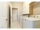 Well-organized laundry room with cabinetry and newer model washer and dryer at 1195 Golf Club Dr, Laughlin, NV 89029