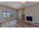 Living room featuring new wood flooring, a fireplace and plenty of natural light at 1195 Golf Club Dr, Laughlin, NV 89029