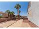 Private walkway and side yard featuring desert landscaping and mature palm trees at 1195 Golf Club Dr, Laughlin, NV 89029