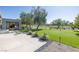 Expansive backyard featuring a putting green, lush landscaping, and a covered patio area with seating at 1337 Villa Barolo Ave, Henderson, NV 89052