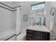 Stylish bathroom featuring a shower-tub combo, modern vanity, and decorative accents at 1337 Villa Barolo Ave, Henderson, NV 89052