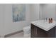 Modern powder room with floating vanity, sleek fixtures, and a decorative art piece at 1337 Villa Barolo Ave, Henderson, NV 89052