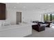 Upstairs living room with wet bar, modern furnishings, and balcony access with natural light at 1337 Villa Barolo Ave, Henderson, NV 89052