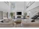 Open concept living room featuring a modern fireplace, high ceilings, and a sleek design at 1337 Villa Barolo Ave, Henderson, NV 89052