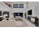 Bright living room with modern fireplace, high ceilings, and access to the backyard at 1337 Villa Barolo Ave, Henderson, NV 89052