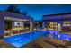 Stunning backyard oasis featuring a pool, spa, covered lounge area, and elegant outdoor furniture at 1337 Villa Barolo Ave, Henderson, NV 89052