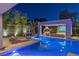 Inviting pool area with a modern cabana, comfortable seating, and beautiful landscaping for relaxing evenings at 1337 Villa Barolo Ave, Henderson, NV 89052