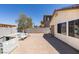 Large backyard patio offers ample space for outdoor dining and entertaining with privacy fence at 1905 Eskam St, Las Vegas, NV 89156