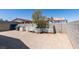 Spacious fenced backyard with a large patio area and mature tree providing shade and character at 1905 Eskam St, Las Vegas, NV 89156