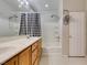 Bathroom with double sinks, a tub with shower, a buffalo check shower curtain, and great lighting at 1905 Eskam St, Las Vegas, NV 89156