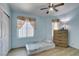Bedroom featuring natural light, wood floors, ceiling fan, and blue walls at 1905 Eskam St, Las Vegas, NV 89156