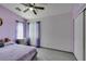 Bedroom with light purple walls, ceiling fan, natural light, and wood floors at 1905 Eskam St, Las Vegas, NV 89156