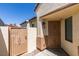 View of the front entrance featuring a decorative metal security door and adjacent gated entrance to the private front courtyard at 1905 Eskam St, Las Vegas, NV 89156