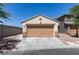 The property features a one-car garage with neutral trim, a spacious driveway, and desert landscaping, with a neighboring two-story house at 1905 Eskam St, Las Vegas, NV 89156
