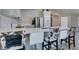 Modern kitchen with stainless steel appliances, white cabinets and counters and decorative bar stools at 1905 Eskam St, Las Vegas, NV 89156