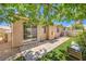 Comfortable backyard featuring artificial turf, desert landscaping, and a sliding glass door entrance to the home at 201 Teller St, Henderson, NV 89074