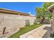Private backyard features a concrete walkway, artificial turf, and desert landscaping elements at 201 Teller St, Henderson, NV 89074