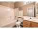 Bathroom featuring a bathtub, toilet, and sink at 201 Teller St, Henderson, NV 89074