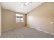 Neutral bedroom with carpet, light walls, a ceiling fan, and a window at 201 Teller St, Henderson, NV 89074