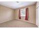 Bedroom with carpet, neutral walls, and window with curtains at 201 Teller St, Henderson, NV 89074
