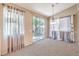 Bright dining area with light-colored walls, soft carpet, and sliding glass doors leading to the backyard at 201 Teller St, Henderson, NV 89074