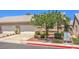 Home exterior with a two-car garage, desert landscaping, tile roof, and a communal mailbox at 201 Teller St, Henderson, NV 89074